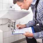 Plumber Writing On Clipboard